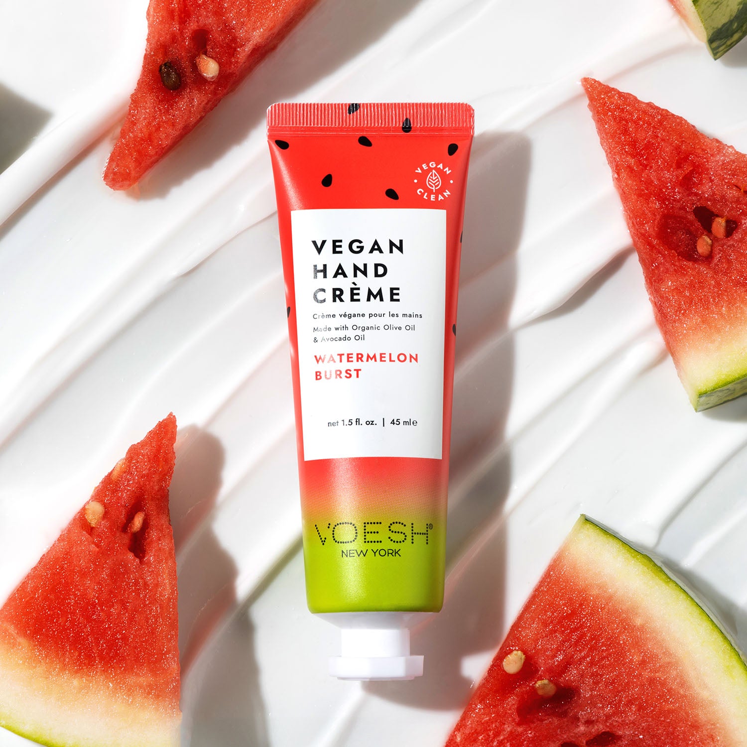 Watermelon Burst Vegan Hand Crème on top of lotion’s texture with watermelon slices.